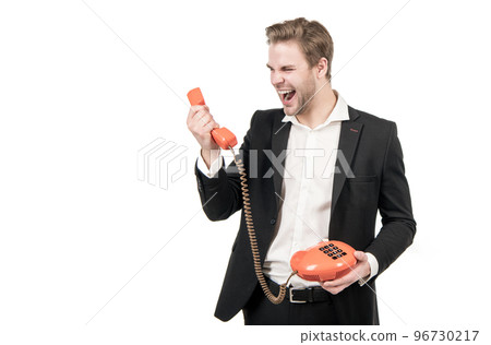 Angry man shout in vintage telephone receiver holding old-fashioned landline phone, telephony 96730217