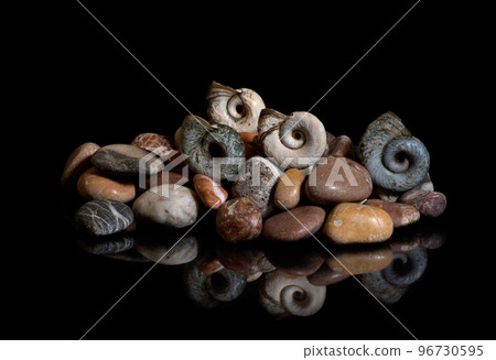 Sea stones, shells are isolated on a black background. In reflection 96730595