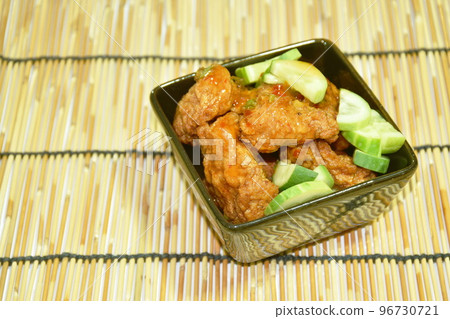 deep fried fish patty dressing slice cucumber in sweet chili sauce on bowl deep fried fish patty dressing slice cucumber in sweet chili sauce on bowl 96730721