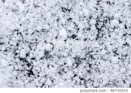 Snow grains and snowflakes are sprinkled on a black background. Freshly fallen snow, winter day Snow grains and snowflakes are sprinkled on a black background. Freshly fallen snow, winter day 96730833