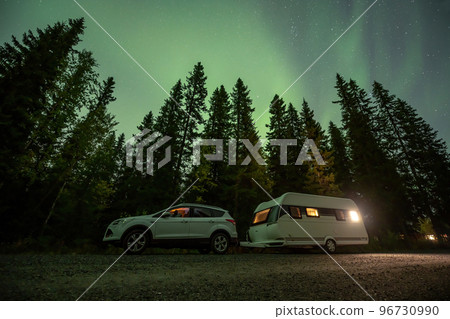 Aurora shining over Camping Caravan in Swedish forest Tannforsen Waterfall Northern Lights color sky Sweden, Scandinavia Aurora shining over Camping Caravan in Swedish forest Tannforsen Waterfall Northern Lights color sky Sweden, Scandinavia 96730990