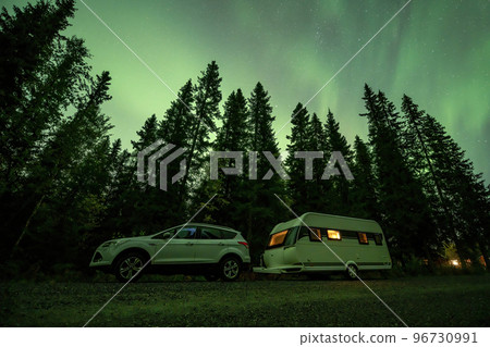Aurora shining over Camping Caravan in Swedish forest Tannforsen Waterfall Northern Lights color sky Sweden, Scandinavia Aurora shining over Camping Caravan in Swedish forest Tannforsen Waterfall Northern Lights color sky Sweden, Scandinavia 96730991