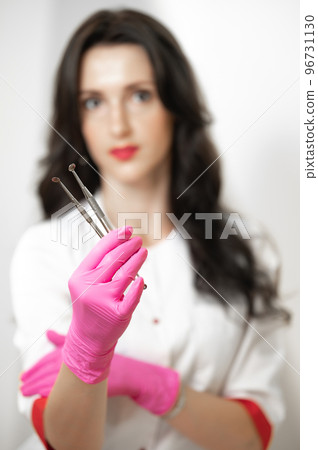 Uno spoons in the hands of a cosmetologist, tools of a cosmetologist for cleaning the face. Uno spoons in the hands of a cosmetologist, tools of a cosmetologist for cleaning the face. 96731130