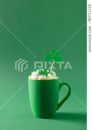 Irish coffee in green cup with whipped cream and sprinkles for St Patricks Day. 96731258