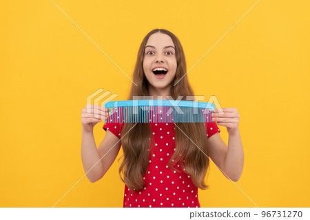 hairdresser. girl has wavy hairdo hold hairbrush. teen beauty hairstyle. portrait of frizz child 96731270