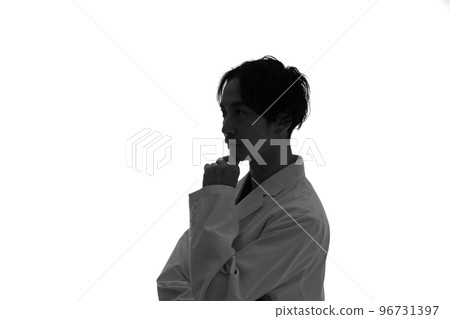 Profile silhouette of a man in a white coat thinking Profile silhouette of a man in a white coat thinking 96731397