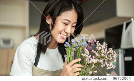 Weekend with her hobbies, Asian woman arranges a bouquet of flowers to decorate her home and beautify, Artificial flower arrangement, living room decoration ideas, Flowers bunch, Arts and crafts 96732964