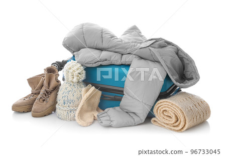 Suitcase with warm clothes isolated on white. Winter vacation Suitcase with warm clothes isolated on white. Winter vacation 96733045