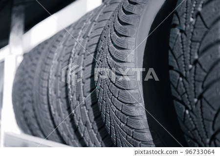 Tires on rack in car service workshop, closeup Tires on rack in car service workshop, closeup 96733064