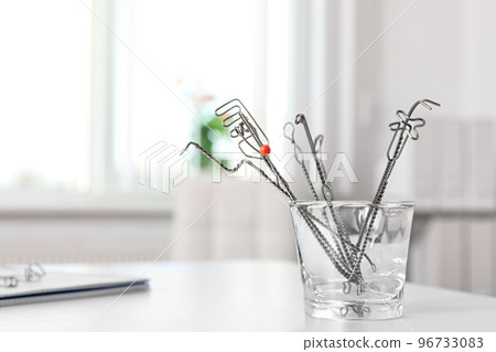 Set of different logopedic probes in holder on light table, space for text. Speech therapist's tools 96733083