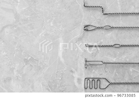 Set of different logopedic probes and space for text on marble table, flat lay. Speech therapist's tools 96733085