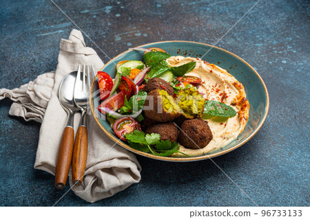 Close up of Middle Eastern Arab meal with fried falafel, hummus, vegetables salad 96733133
