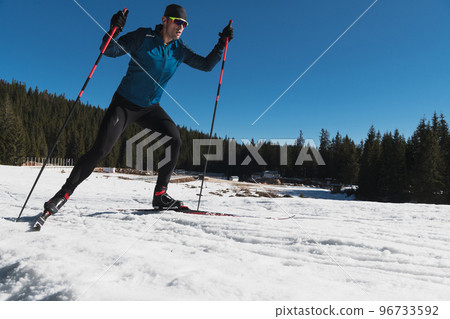 Nordic skiing or Cross-country skiing classic technique practiced by man in a beautiful panoramic trail at morning. Nordic skiing or Cross-country skiing classic technique practiced by man in a beautiful panoramic trail at morning. 96733592