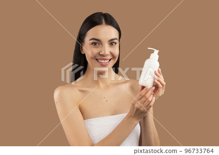 Close up portrait of beautiful half-naked woman showing beauty product Close up portrait of beautiful half-naked woman showing beauty product 96733764