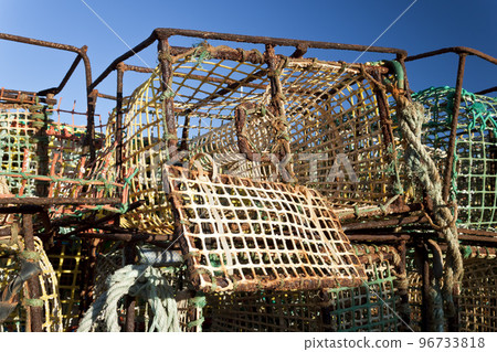 Pile of crab fishing pots on the waterfront of fishing port 96733818