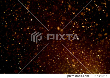 Natural organic golden dust particles floating on black background. Glittering sparkling flickering glowing. 96734034