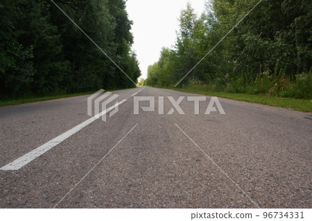 Asphalt gray road among greenery low plan Asphalt gray road among greenery low plan 96734331