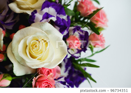 Background. Bouquet of flowers close-up on a white background. White and pink roses, blue-white eustoma. Place for text. 96734351