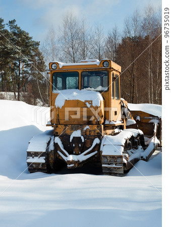 Bulldozer on the snow in winter. Bulldozer on the snow in winter. 96735019