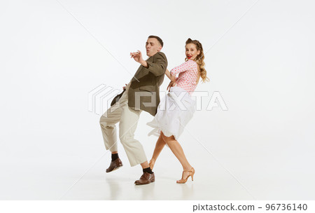 Two emotional dancers in vintage style clothes dancing swing dance, rock-and-roll or lindy hop isolated on white background. 1960s american fashion style and art. 96736140