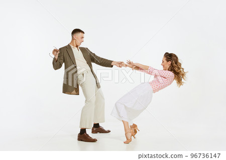 Two emotional dancers in vintage style clothes dancing swing dance, rock-and-roll or lindy hop isolated on white background. 1960s american fashion style and art. 96736147
