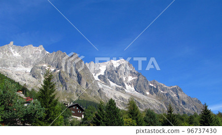 Mont Blanc, highest peak of Alps on border of Italy and France. High mountains with snowy peaks against blue sky, beautiful landscape Monte Blanco 96737430
