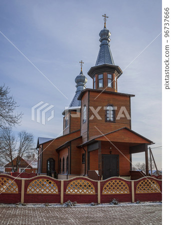 View of Orthodox Church of St. Michael on outskirts of Belarusian village of Lyaskovichi in January. View of Orthodox Church of St. Michael on outskirts of Belarusian village of Lyaskovichi in January. 96737666