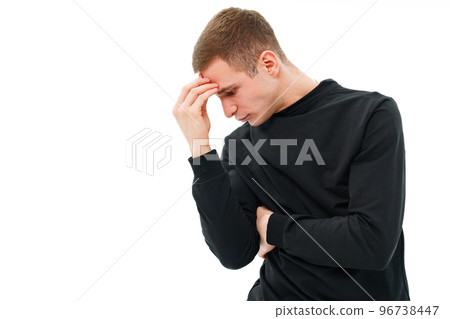 a man in black clothes holds on to head in the pose of a thinker on a white. a man in black clothes holds on to head in the pose of a thinker on a white. 96738447