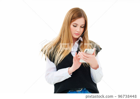 a blonde with a smartphone in hand makes purchases in the online store 96738448