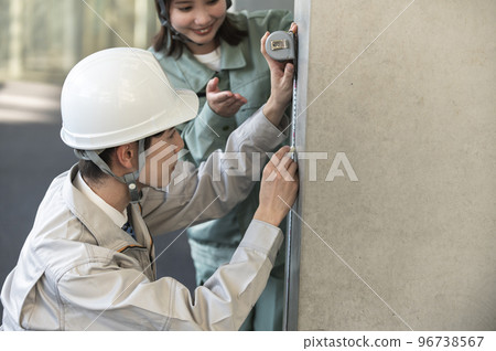 一名男初級工程師在一名女高級工程師的指導下工作 96738567