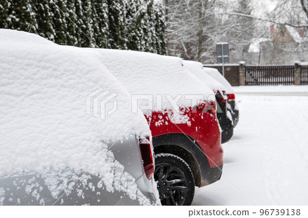 Snow-covered cars in the parking lot. Snow storm and blizzard Snow-covered cars in the parking lot. Snow storm and blizzard 96739138