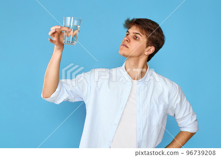Young handsome man with drinking glass of water 96739208