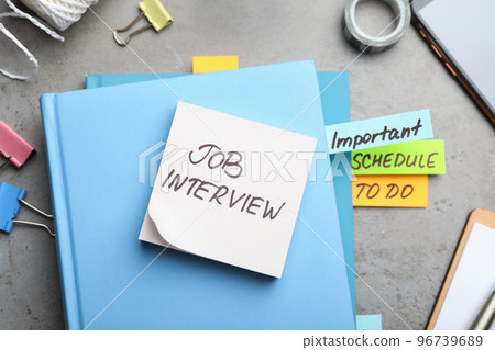 Reminder note about job interview and stationery on table, flat lay 96739689