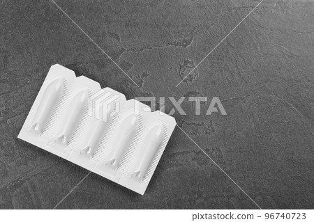 Suppositories and space for text on grey background, top view. Hemorrhoid treatment Suppositories and space for text on grey background, top view. Hemorrhoid treatment 96740723