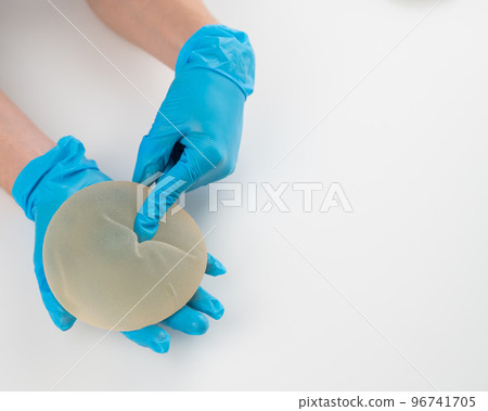 A plastic surgeon shows a breast silicone implant. A plastic surgeon shows a breast silicone implant. 96741705