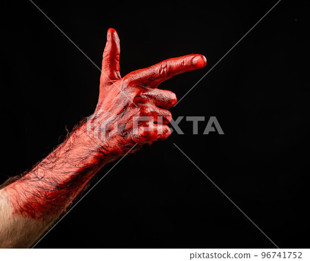 Bloody male hand gesturing shows a gun against black background. Bloody male hand gesturing shows a gun against black background. 96741752