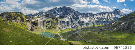 BANNER, LONG FORMAT Mountain lake landscape on Durmitor mountain in Montenegro beautiful Durmitor National park with lake glacier and reflecting mountain Portrait of a disgruntled girl sitting at a 96741856