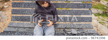 Little boy playing with drone in summer day outdoors BANNER, LONG FORMAT 96741996