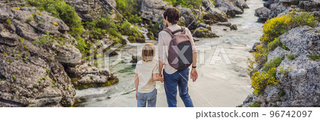 BANNER, LONG FORMAT father and son tourists on background of Picturesque Niagara Falls on the river Cievna. Montenegro, near Podgorica. Travel around Montenegro concept 96742097