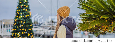 Woman on the background of the Christmas tree. Christmas in the port. Montenegro, Porto Montenegro BANNER, LONG FORMAT 96742128
