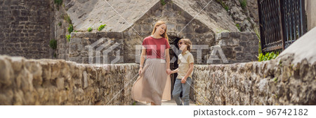 BANNER, LONG FORMAT Mom and son tourists in Herceg Novi old town. Historical and touristic center of Herceg Novi. Montenegro 96742182