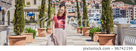 BANNER, LONG FORMAT Woman tourist enjoying the views of Architecture and luxury yachts in Lustica Bay, Montenegro. Travel around Montenegro concept. Go Everywhere BANNER, LONG FORMAT Woman tourist enjoying the views of Architecture and luxury yachts in Lustica Bay, Montenegro. Travel around Montenegro concept. Go Everywhere 96742199