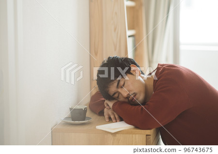 man falling asleep reading a book man falling asleep reading a book 96743675