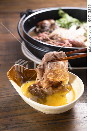 Add sukiyaki meat to eggs 96743836