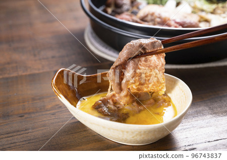 Add sukiyaki meat to eggs Add sukiyaki meat to eggs 96743837