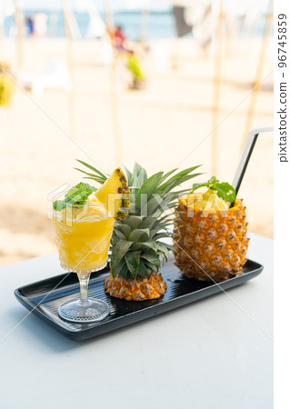 pineapple smoothies with sea beach background pineapple smoothies with sea beach background 96745859