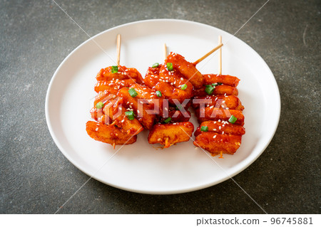 deep fried Korean rice cake (Tteokbokki) skewered with spicy sauce deep fried Korean rice cake (Tteokbokki) skewered with spicy sauce 96745881