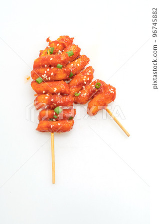 deep fried Korean rice cake (Tteokbokki) skewered with spicy sauce 96745882