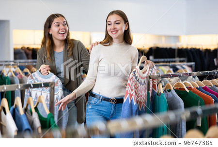 Two women shopping warm clothes in store Two women shopping warm clothes in store 96747385