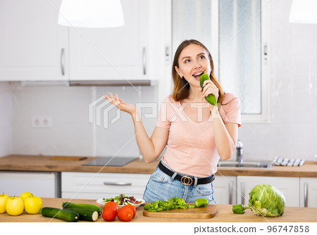 Woman cooking and having fun at kitchen 96747858